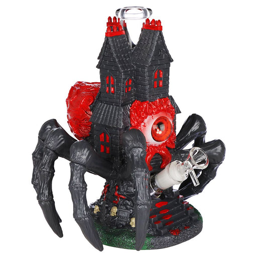 Decorative figurine of a haunted house with red accents on a white background