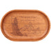 An oval wooden tray with a warm medium-brown finish, featuring an engraved illustration of a wizard holding a staff and mountains, with Elvish script text on the top right.