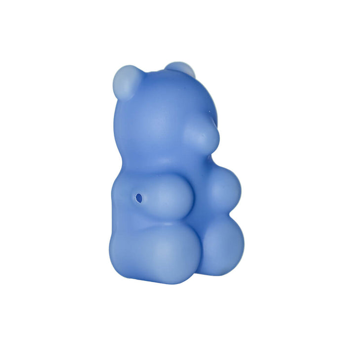 Blue gummy bear-shaped object on a white background