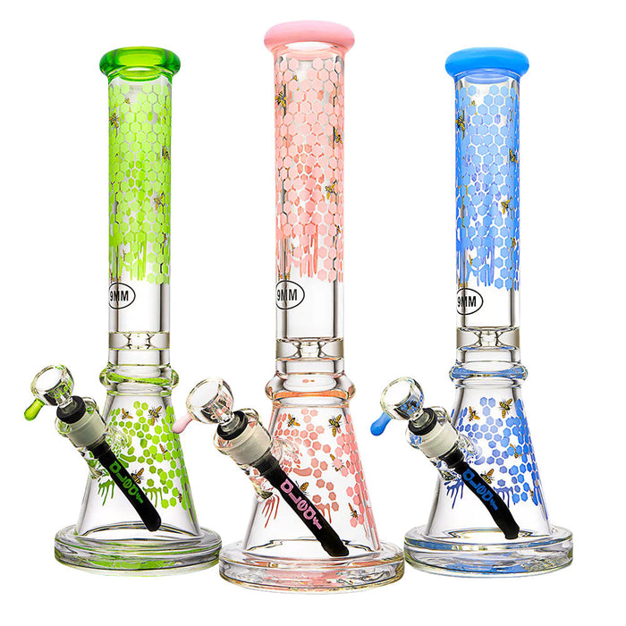 Three colorful glass smoking accessories with different designs on a white background