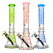 Three colorful glass smoking accessories with different designs on a white background