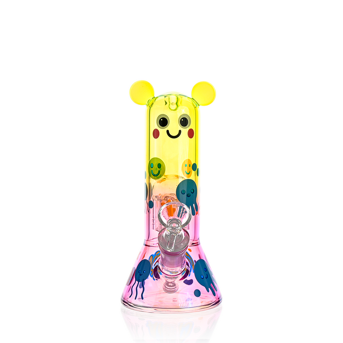Colorful glass smoking device with cartoon face on a white background