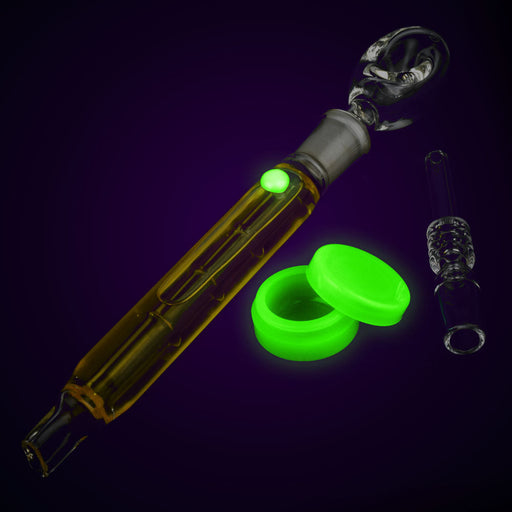 Glass smoking accessory with green glowing components on a dark background