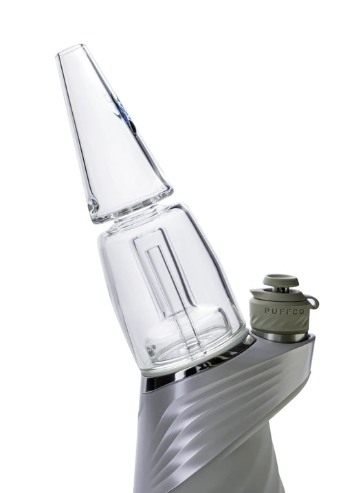 Clear glass smoking device with metallic base on a white background