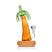 Palm tree-shaped glass bottle with wooden base on a white background