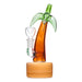 Glass smoking device shaped like a palm tree on a white background