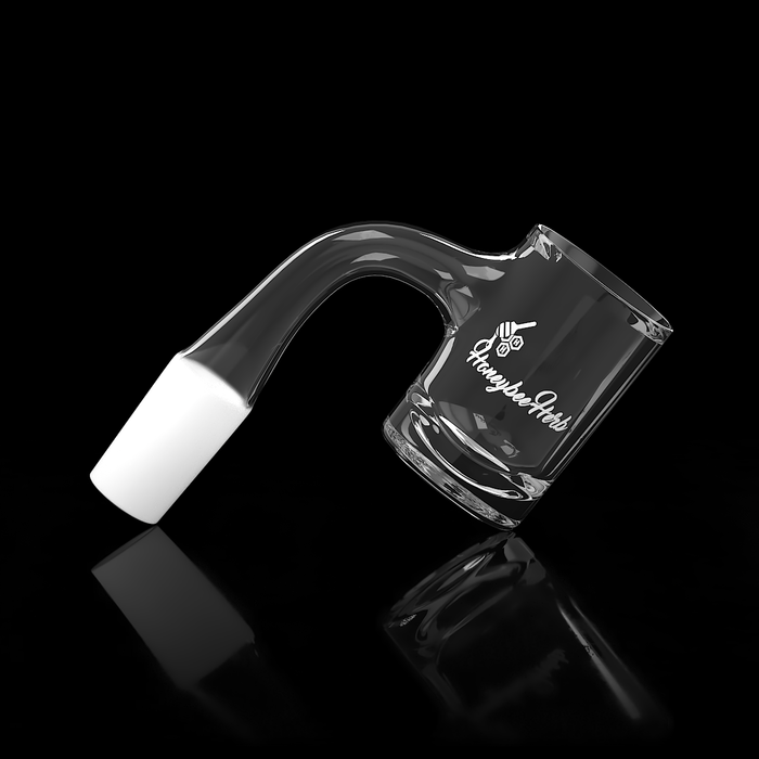 Glass smoking accessory with white accent on a black background