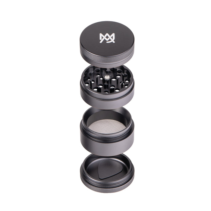 Black metal grinder with four parts on a white background