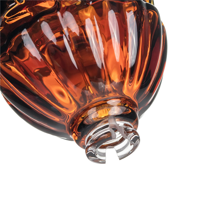 Close-up of a glass with amber-colored liquid on a white background