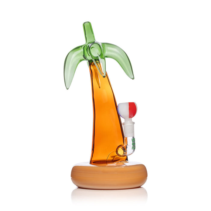 Palm tree-shaped glass water pipe with wooden base on a white background
