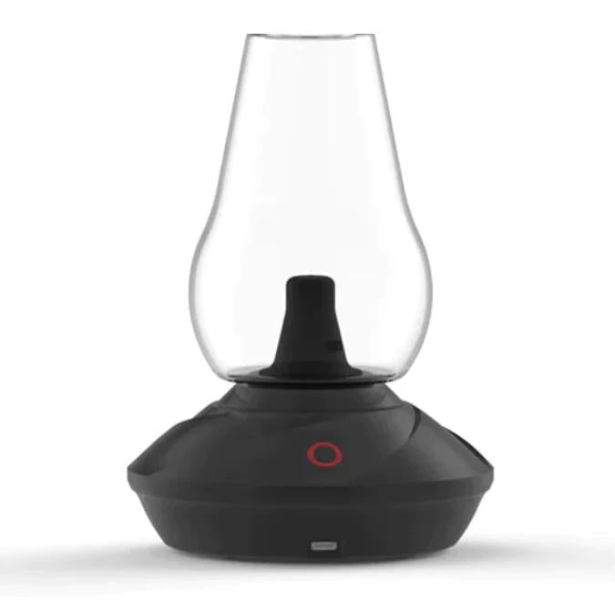 Black and glass lamp-like device on a white background